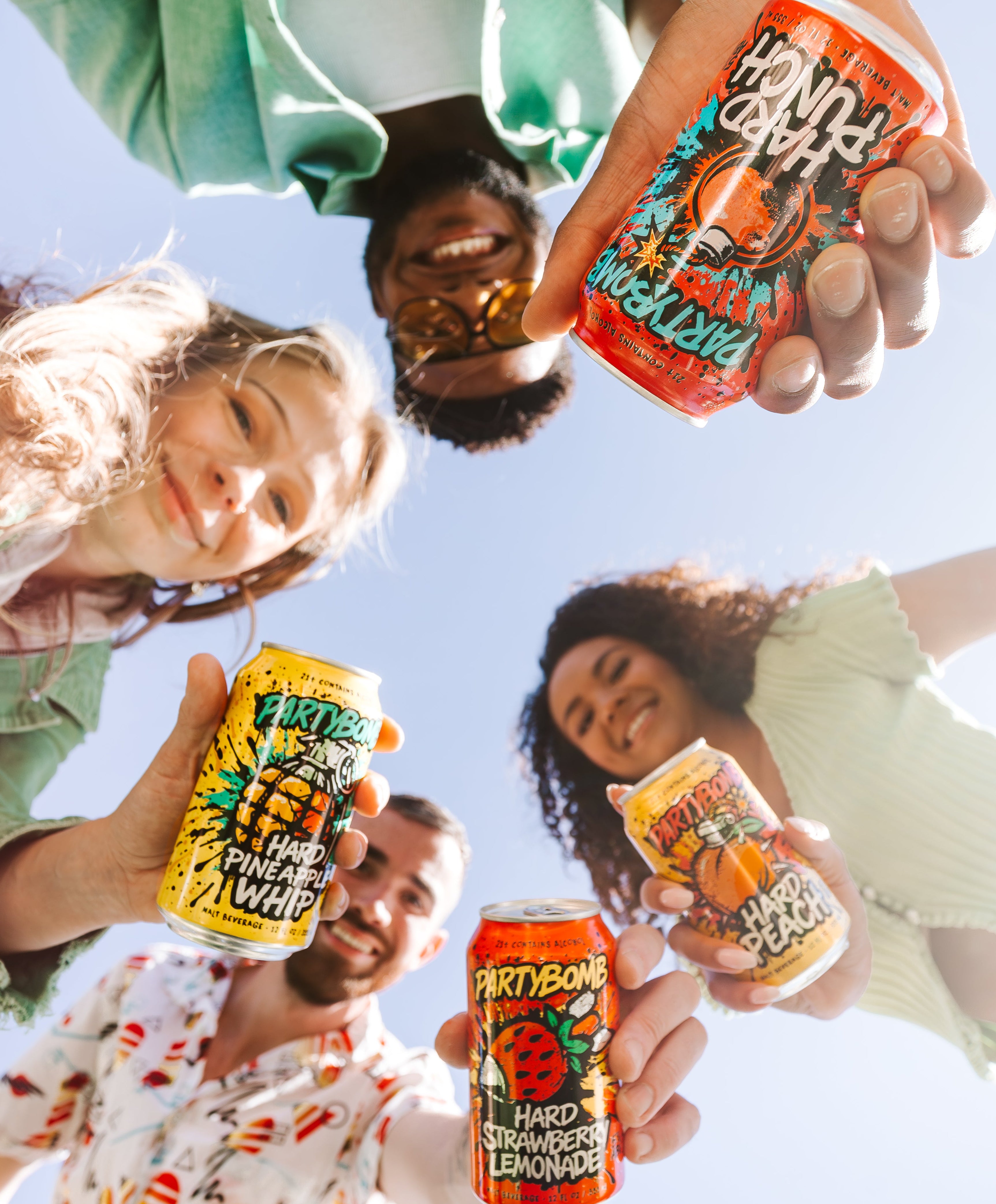 Four people holding the various flavors from the PartyBomb Blast Pack