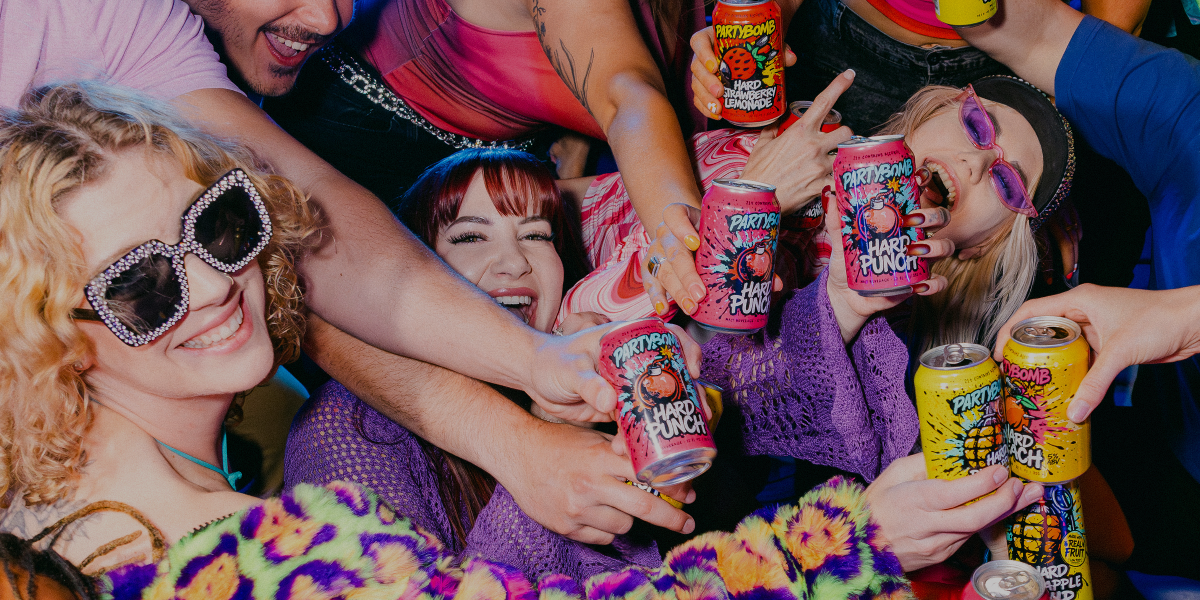 A group of people at a party or concert cheering and holding cans of Fyfe Happy Fyfe Energy Drink, with colorful sunglasses, sunglasses on heads, and a festive atmosphere.